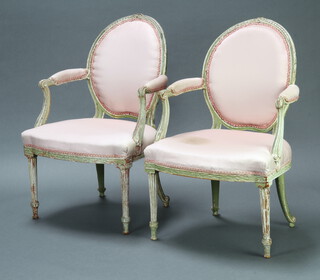 A pair of 19th/20th Century French white painted open arm salon chairs, the seats and backs upholstered in pink material, raised on turned and fluted supports 96cm h x 63cm w x 50cm d (seat 39cm x 34cm) 