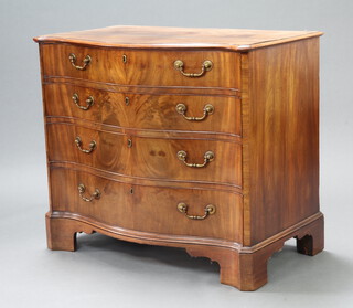 A Georgian serpentine fronted mahogany chest of 4 long drawers with original brass swan neck drop handles and escutcheons, raised on bracket feet, the top drawer with fitted sections and inset leather writing surface 82cm h x 95cm w x 56cm d  