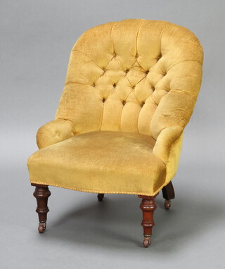 A Victorian tub back nursing chair upholstered in yellow buttoned material raised on turned supports 77cm h x 55cm w x 48cm d (seat 34cm x 35cm) 