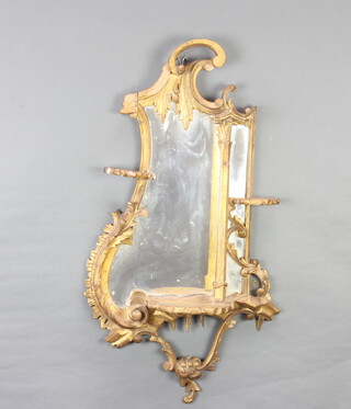 A Chippendale style plate mirror contained in a decorative frame fitted a shelf 80cm x 44cm section of gilt carving missing to the top 