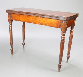 A Georgian mahogany D shaped tea table raised on turned supports 74cm h x 96cm w x 42cm d 