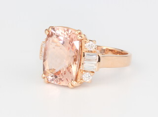 An 18ct rose gold Morganite and diamond ring the centre stone 5.93ct flanked by baguette diamonds 0.25ct and brilliant cut diamonds 0.22ct, size M 1/2, 6.7 grams