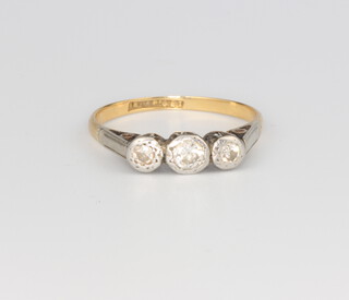 An 18ct 3 stone illusion set diamond ring, 2 grams, size M 1/2