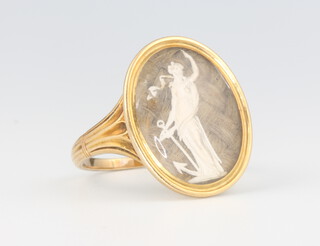 A 19th Century yellow metal oval mourning ring with plaited hair and a figure of a standing classical lady 4.5 grams, size O 1/2 