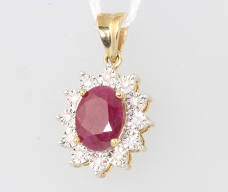 A 9ct yellow gold oval ruby and diamond cluster pendant, centre oval stone 1.8ct, surrounded by brilliant cut diamonds approx 0.12ct, 22mm, 2.3 grams