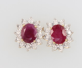 A pair of 9ct yellow gold oval ruby and diamond ear studs, the rubies 3.85ct and diamonds 0.24ct, 15mm x 12mm, 5.1 grams