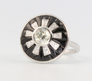 An 18ct white gold Art Deco style diamond and onyx target ring, the centre stone approx. 0.7ct, size N 1/2, 5.8 grams 