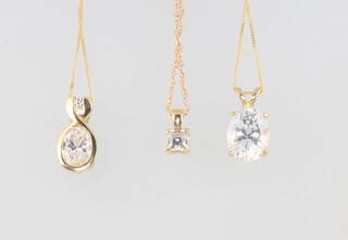 Three 14ct yellow gold chains with paste set pendants, 5.5 grams 