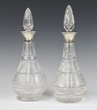 A near pair of cut glass mallet shaped decanters and stoppers with silver collars Birmingham 1936 30cm 
