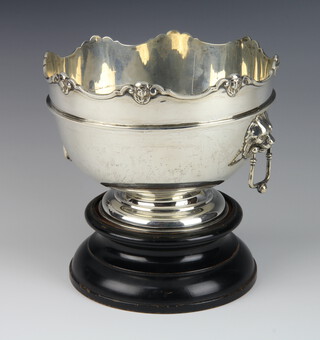 An Edwardian silver monteith with mask rim and lion drop handles, London 1905, 15cm, 600 grams, raised on a wood socle  