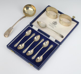 A pair of oval silver napkin rings Sheffield 1944, a George IV ladle, a George III silver teaspoon and 6 teaspoons Sheffield 1973, 220 grams 
