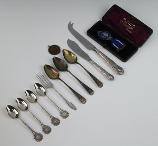 A Georgian silver teaspoon, 2 others, 4 teaspoons, a fork and enamelled medallion 110 grams