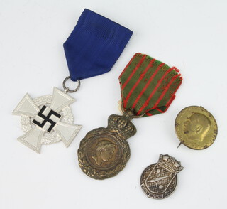 A French medal St Helena, a Third Reich Faithful Service medal, a Minesweeper badge and a pin 