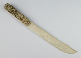 A Meiji period carved ivory paper knife the reticulated handle enclosing figures 40cm 
