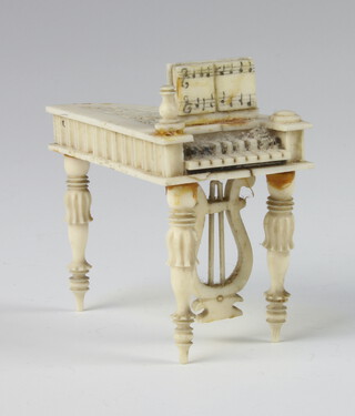 A 19th Century carved ivory miniature model of a piano forte 6cm 