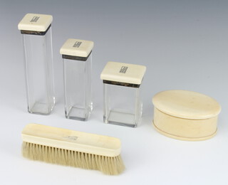 A set of silver and ivory mounted Art Deco dressing table bottles London 1939 comprising 2 square bottles, a rectangular ditto, a clothes brush and an oval box and cover 