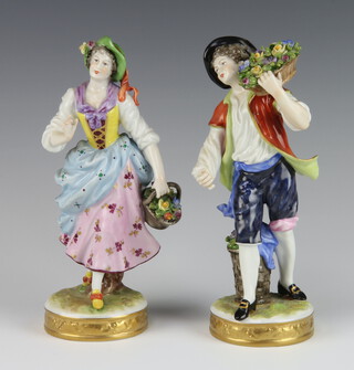 A pair of Volkstedt porcelain figures of a female and male flower seller raised on circular bases 20cm 
