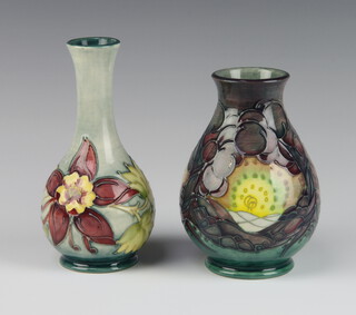 Moorcroft, a contemporary baluster vase decorated the Seasons pattern 13cm, a pale blue ground ditto decorated the columbine design 15cm 