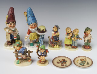 Two Hummel figures of gnomes Well 317, 19cm (chipped) a ditto Well 506, 19cm (chipped) five figures and two dishes