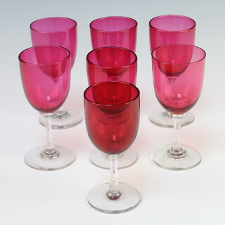 A harlequin set of 7 cranberry sherry glasses 