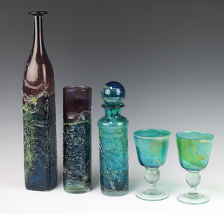 Two Mdina goblets 16cm, a cylindrical decanter and stopper 29cm, a cylindrical vase 27cm and an elongated square bottle vase 47cm 