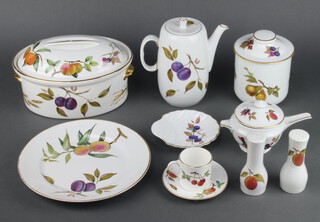 An extensive Royal Worcester Evesham tea, coffee and dinner service comprising 6 coffee cans, 6 saucers, 6 tea cups, 6 saucers, 12 small plates, 6 side plates, 6 dinner plates, 6 two handled cups, 6 saucers, 2 souffles, sauce boat and stand, 2 oval dishes, 2 oval serving dishes, a flan dish, a shell butter dish, 6 dessert bowls, serving dish, a butter dish and cover, a tureen and lid, 6 sweetcorn dishes, 2 oil bottles, 3 condiments, an oval dish and cover, a casserole and cover, an oval serving plate, coffee pot, storage jar, cake slice, butter knife and 1 odd lid   