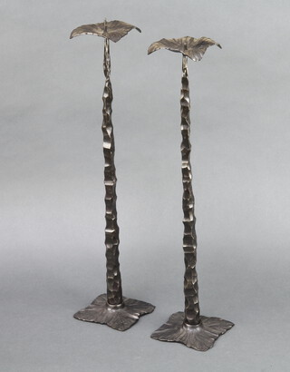 A pair of Art Nouveau style hammered iron pricket candlesticks with leaf shaped sconces and bases marked AP 48cm x 10cm x 10cm 