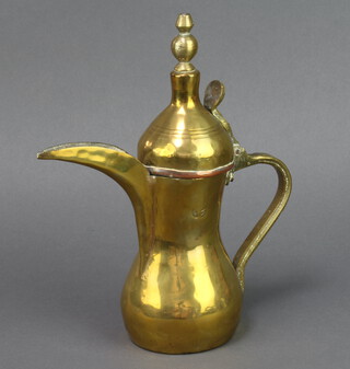 A Turkish brass coffee pot with signature mark to sides, 23cm h x 8cm 

