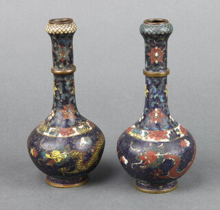A pair of Japanese black ground cloisonne enamel club shaped vases decorated dragons, the base with signature mark 14cm h x 3cm diam.  