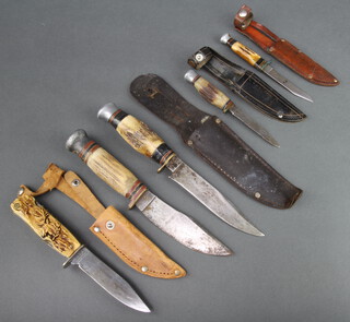 A D.B.G.M. Bowie style knife, the 9cm blade marked Decora-Solingen with simulated stag horn grip, fitted a corkscrew, screwdriver, saw and file complete with leather scabbard, a Bowie style knife with blade marked Sword Play with stag horn handle 10cm, 1 other with leather scabbard and 2 small Bowie knives 
