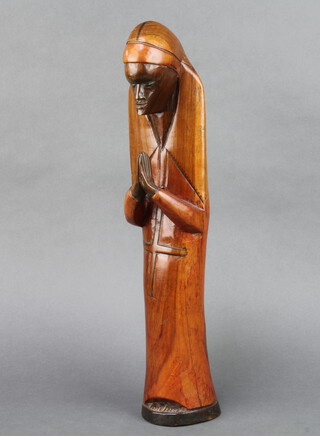 An African carved hardwood figure of a standing figure in prayer 47cm x 8cm x 9cm 