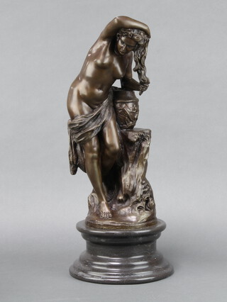 A bronze figure of a standing semi-naked classical lady raised on turned black marble base 49cm h x 21cm diam. 