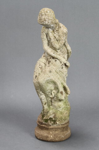 A well weathered reconstituted stone figure of a seated girl 71cm h x 20cm diam. 