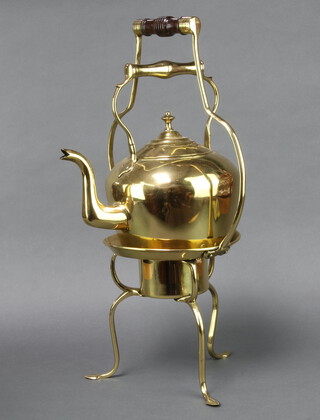 A large and impressive Art Nouveau brass tea kettle and stand, raised on cabriole supports 56cm h x 29cm diam. 
