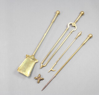 A Victorian brass 3 piece fireside companion set with poker, tongs and shovel together with a Adam style brass poker and poker stand 