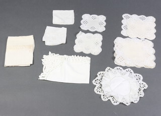 A collection of 19th Century table linens, napkins, doilies in a white plastic crate