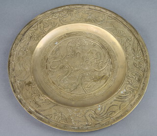 A Chinese gilt metal charger decorated a dragon the reverse with seal mark, marked china 31cm diam. 