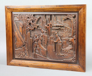 A Chinese carved hardwood panel decorated figures before pagodas 38cm x 49cm 