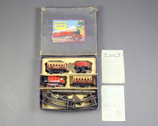 A Hornby O gauge M1 passenger clockwork train set comprising locomotive, tender, 2 carriages, rails and key, boxed 