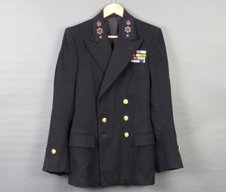 Burtons, a Royal Naval petty officer's tunic (1 cuff button torn) together with a Royal Naval Jaeger commander's great coat (some moth) 