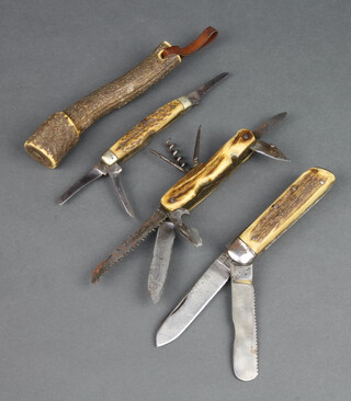 G Rogers & Sons, a twin bladed folding pocket knife with knife and saw and stag horn grip, a 19th Century multi bladed pocket knife with saw, blade, screwdriver, 2 small blades, bodkin, corkscrew and gimlet and stag horn grip, 1 other and a stag horn priest