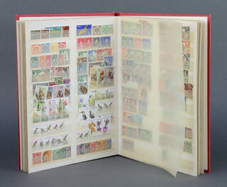 A red stock book containing British and Commonwealth stamps Victoria to Elizabeth II, mint and used Fiji to Mauritius Island (catalogue value 2,800 pounds) 
