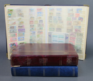A stock book of George VI to Elizabeth II stamps Tonga, Trinidad and Tobago and Jersey mint and used, a red stock book of George V and later Jamaica, Cook Islands and a blue stock album of Cayman Island stamps 