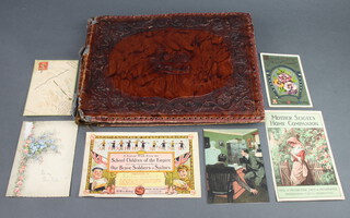 A leather covered scrapbook containing cut scraps  