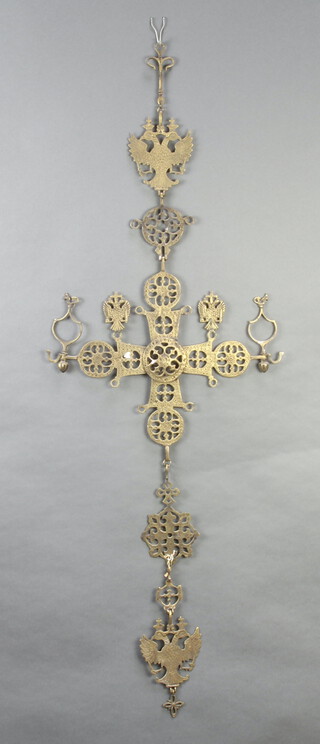 A Russian pierced gilt metal hanging cross surmounted by a double headed eagle 90cm x 109cm x 40cm 