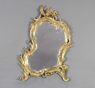 A 19th/20th Century shaped plate mirror contained in a rococo style gilt frame 52cm x 34cm 
