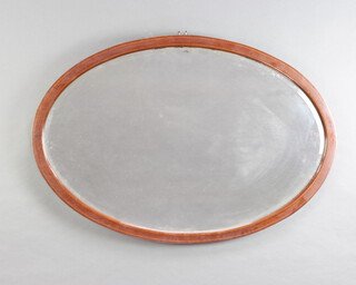 An Edwardian oval bevelled plate wall mirror contained in an inlaid mahogany frame 62cm x 92cm