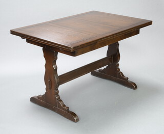 An Ercol dark elm draw leaf dining table with H framed stretcher 74cm h x 114cm l x 79cm w