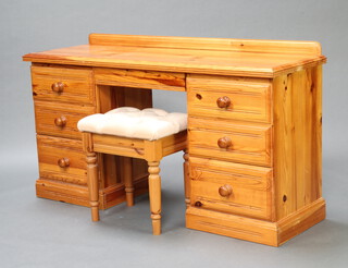 A pine dressing table with raised back fitted 1 long and 6 short drawers with tore handles 80cm h x 138cm w x 45cm d, together with a matching stool upholstered in cream buttoned material 