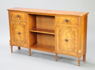 A Queen Anne style figured walnut serpentine fronted bookcase with crossbanded top, fitted a recess flanked by cupboards with drawers above, raised on turned supports 72cm h x 127cm w x 25cm d  